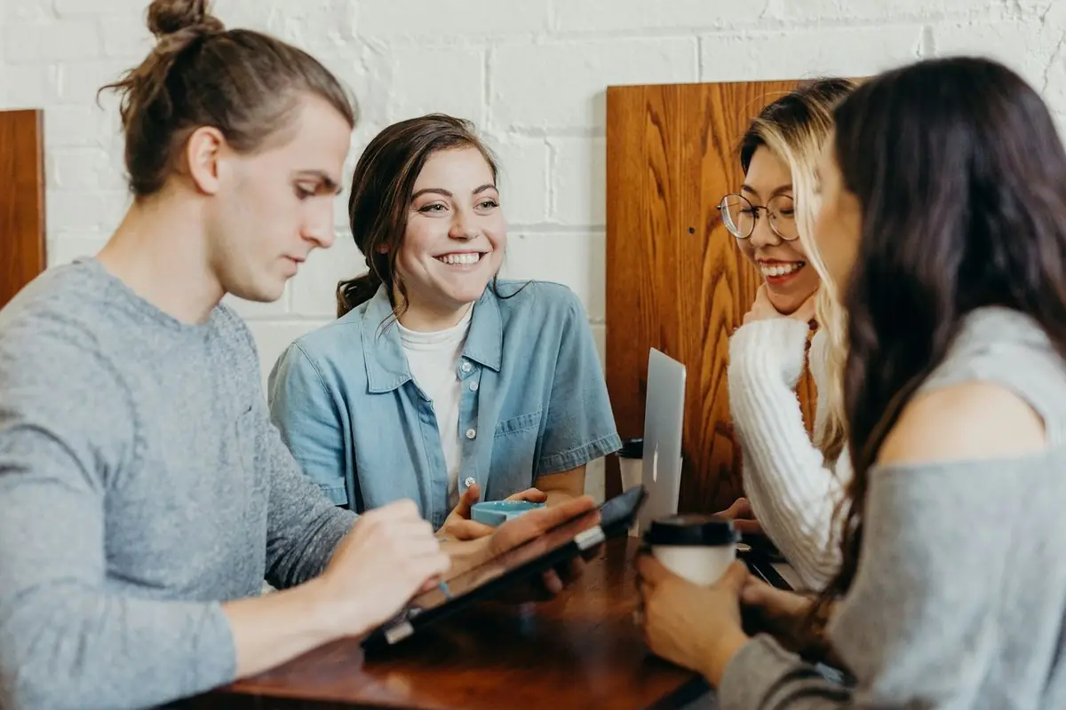 Friends studying and talking together around a café table